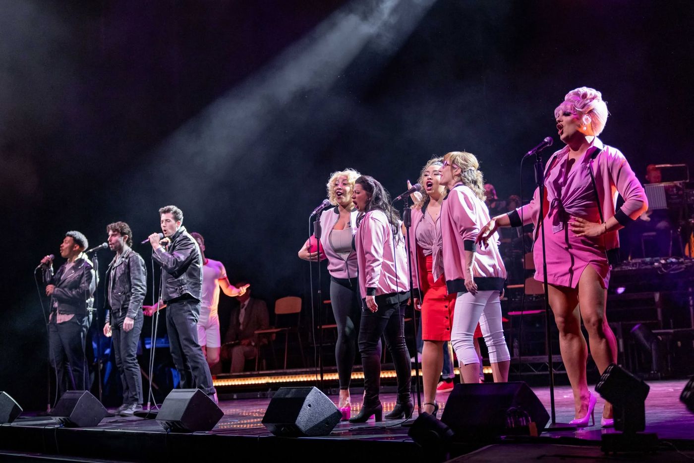 The company in pink and white at microphones