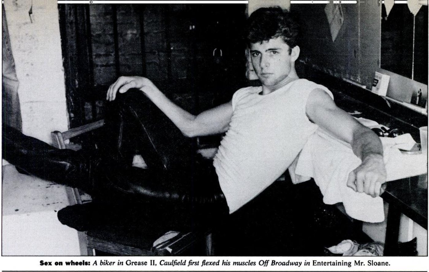 Black and white magazine photo of Maxwell Caulfield in a white vest and leather trousers, seated backstage